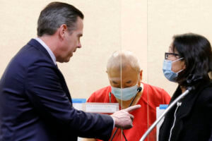 Chunli Zhao, center, appears for a plea hearing with his defense attorney Eric Hove