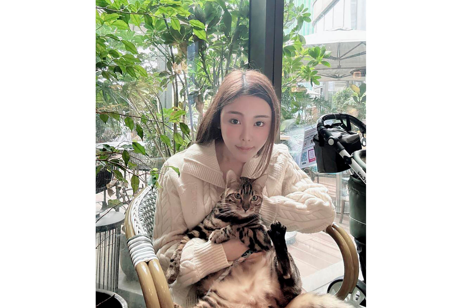 model Abby Choi, holding a cat, poses for a photo on Feb. 11, 2023, in Hong Kong