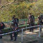 police officers prepare to conduct a search on a hillside following a murder case of Abby Choi