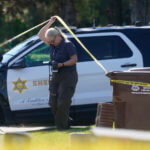 A forensic investigator leaves the home of Bishop David O'Connell