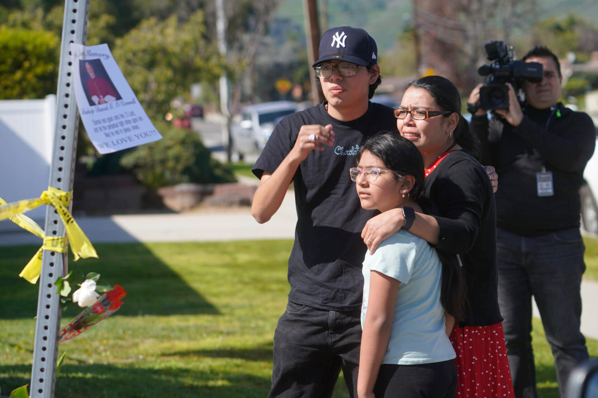 Gabriela Gil and her children pay their respects to Bishop David O'Connell