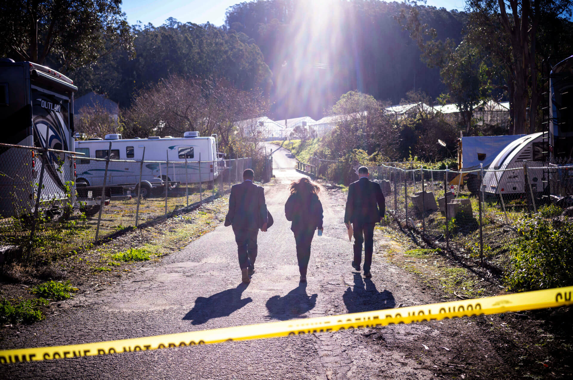 FBI officials walk towards the crime scene at Mountain Mushroom Farm