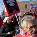 People participate in a march in downtown Rapid City, S.D., Thursday, Feb. 14, 2019