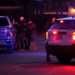 A Las Vegas police officer stands near the home of former actor Nathan Lee Chasing His Horse