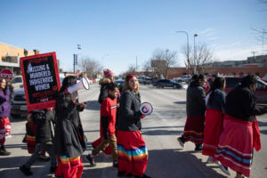 People participate in a march in downtown Rapid City, S.D., Thursday, Feb. 14, 2019