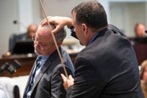 Crime scene specialist Kenneth Kinsey, right, shows where he believes a shotgun round entered Paul Murdaugh