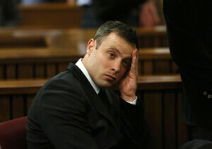 Oscar Pistorius gestures, at the end of the fourth day of sentencing proceedings