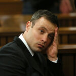 Oscar Pistorius gestures, at the end of the fourth day of sentencing proceedings