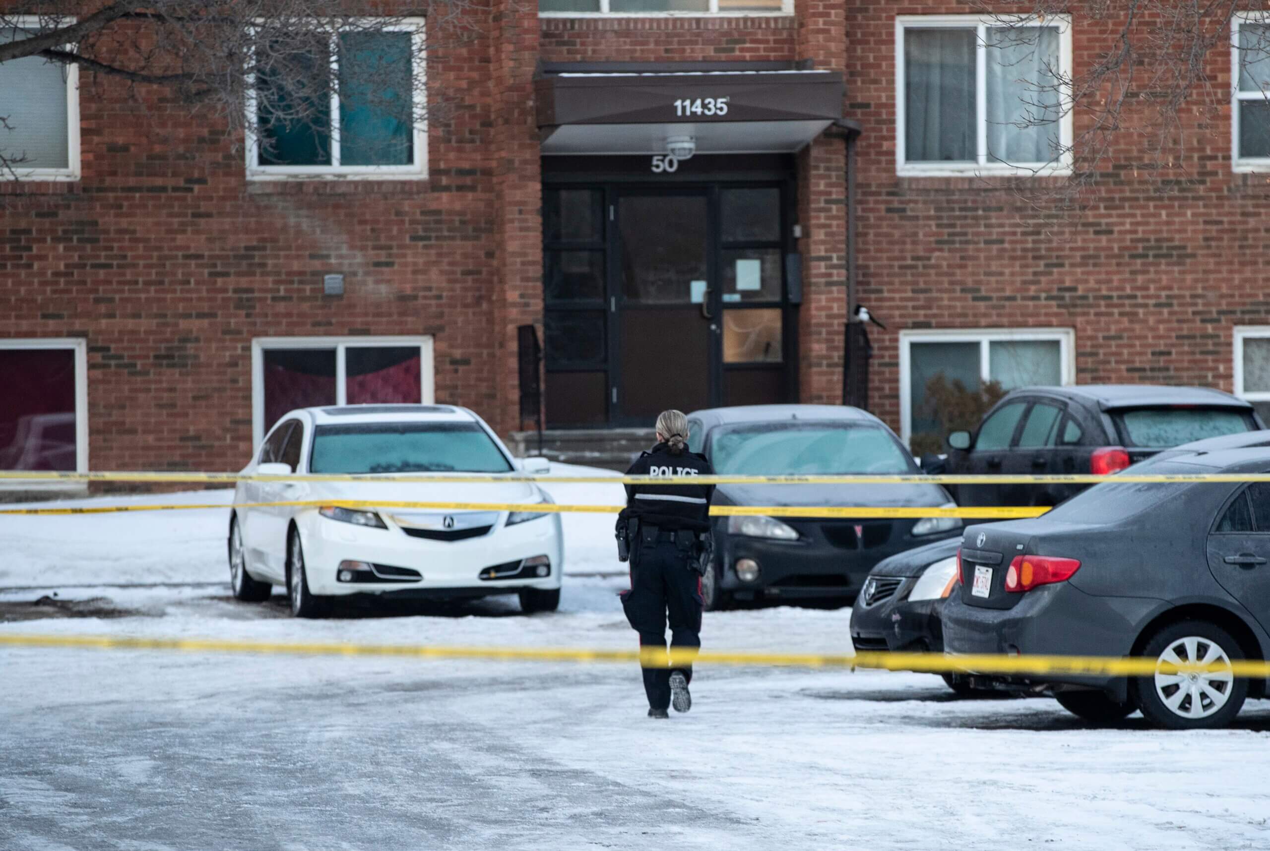 Police investigate the scene where two officers were shot and killed
