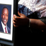 Caroline Ouko, mother of Irvo Otieno, holds a portrait of her son