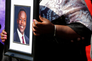 Caroline Ouko, mother of Irvo Otieno, holds a portrait of her son