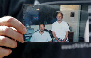 Eric Paddock holds a photo of himself, at left, and his brother, Las Vegas shooter Stephen Paddock