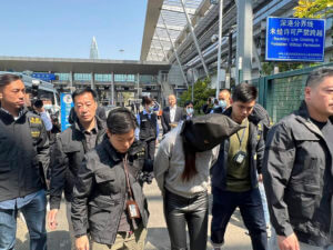 olice escort a suspect at the Shenzhen Bay Port border crossing in Hong Kong