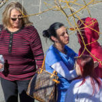 Hospital staffer consoles students outside Providence Santa Rosa Memorial Hospital.