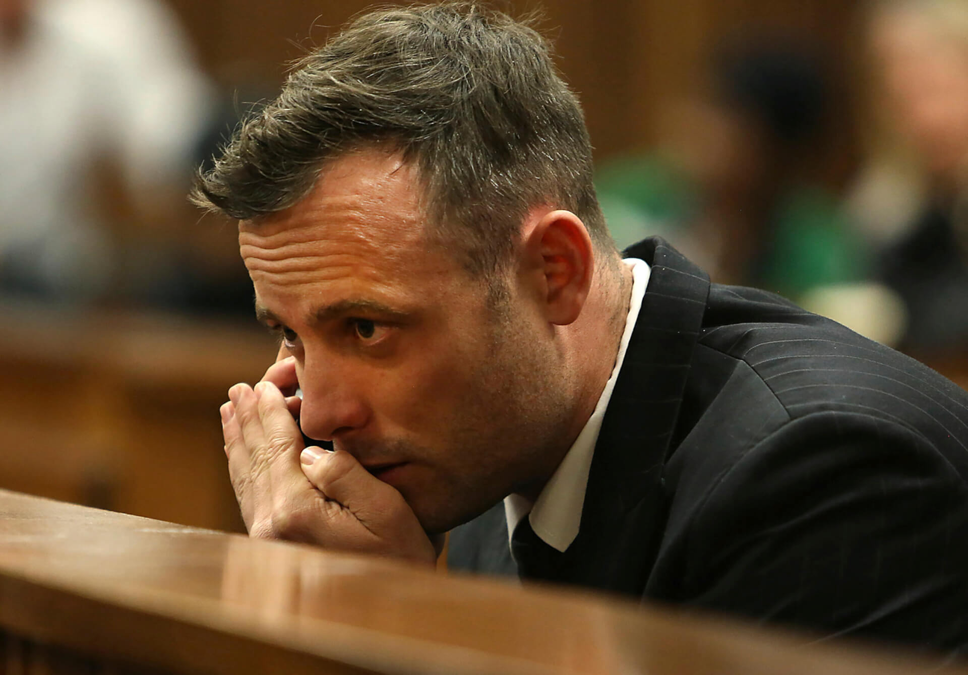 Oscar Pistorius speaks on a mobile phone in the High Court in Pretoria