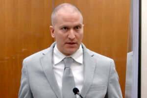 Derek Chauvin, dressed in a suit, addresses the court.