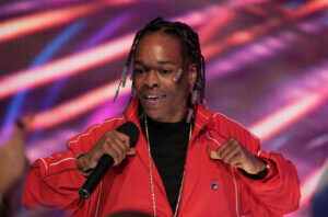 Photo of Christopher Dooley, known as Hurricane Chris, holding a microphone.