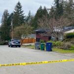 Crime scene tape surrounds a home in Redmond, Wash