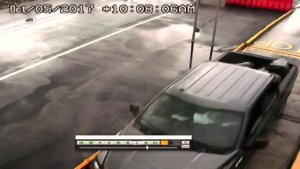 surveillance video image of ford f-150 with trash bags in back
