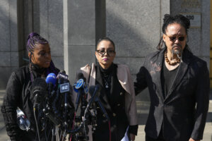 Kathryn Townsend Griffin, center, daughter of singer and songwriter Ed Townsend, speaks outside New York Federal Court 