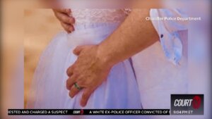 close up of a man's hand on a woman's rear in a wedding dress