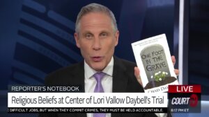 Vinnie Politan holds up a copy of Chad Daybell's book, 