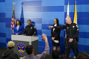 San Francisco Police Chief William Scott, second from left, answers questions from reporters