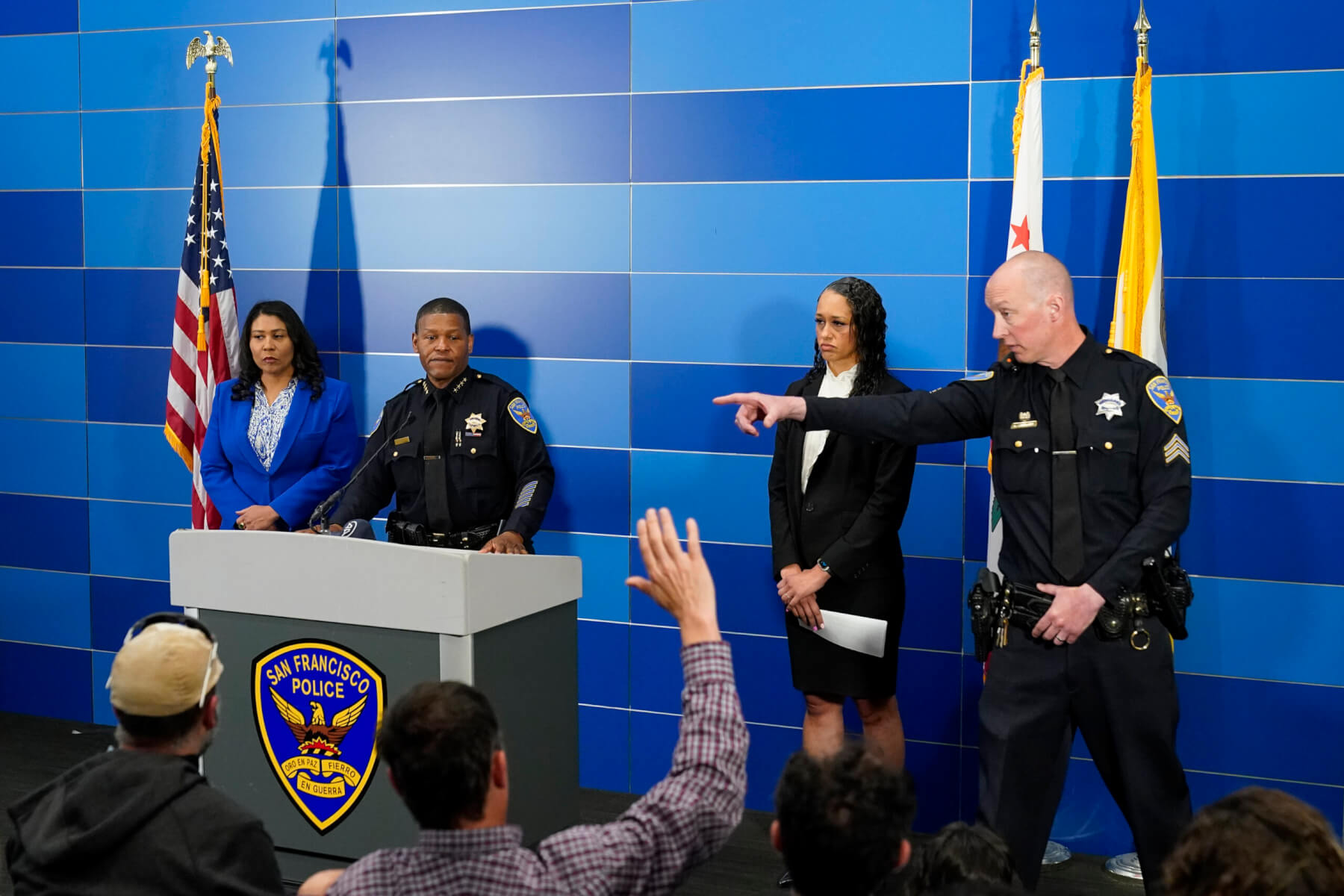 San Francisco Police Chief William Scott, second from left, answers questions from reporters