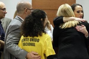 Judge Elizabeth Scherer hugs Jennifer Guttenberg following the sentencing