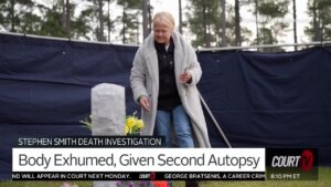 Stephen Smith's mother places flowers at her son's grave.