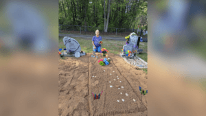 Sandy smith sits at fresh gravesite