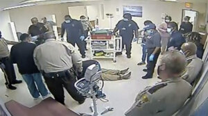 surveillance camera of deputies and hospital employees appearing to administer CPR as Irvo Otieno, center, lies on the floor