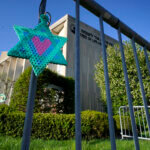 A Star of David hangs from a fence outside the dormant landmark Tree of Life synagogue