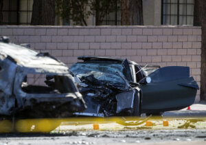 A crushed corvette at a crash scene