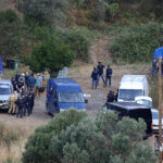 Police officers talk by an operation tent near Barragem do Arade