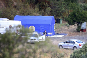 A police tent and vehicles are seen near the Arade dam