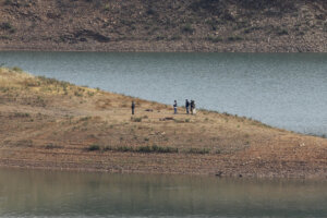 Police work on the banks of the Arade dam