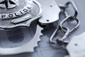 stock photo of handcuffs and police badge