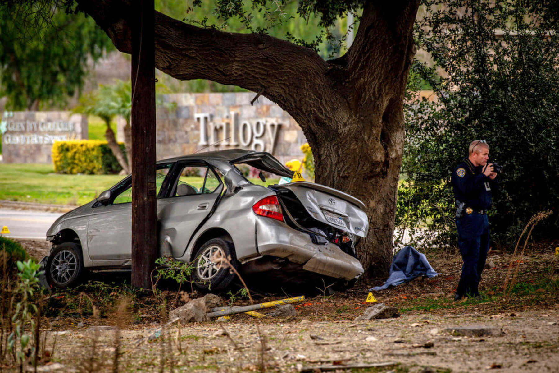  A police officer investigates the scene of a car accident involving a teenager in India.