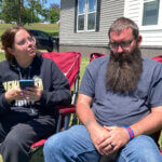 Justin Webster and his wife, Ashleigh, sit outside their Henryetta, Oklahoma, home