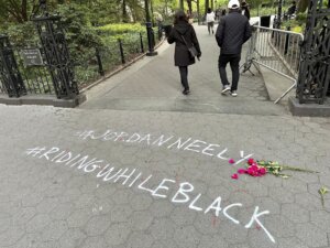 People walk past graffiti calling attention to death of Jordan Neely