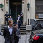 Daniel Penny, center, is walked by New York Police Department detectives