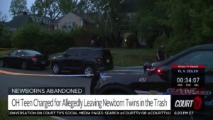 police vehicles and crime scene tape outside of a home