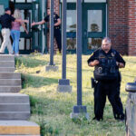 Law enforcement stand outside of Henryetta High