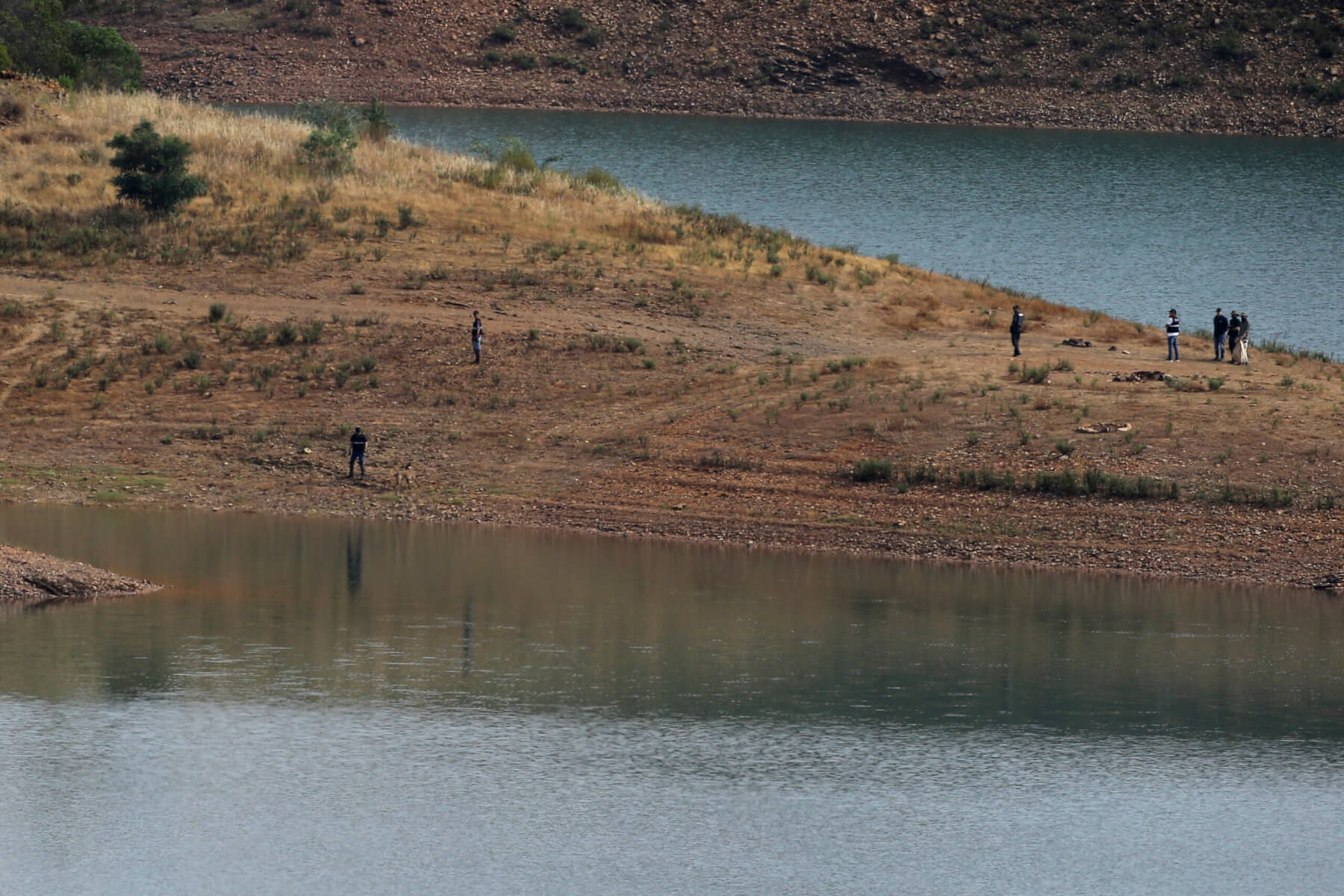 Police work on the banks of the Arade dam