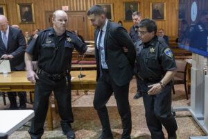 Nauman Hussain is taken into custody in court after his conviction.