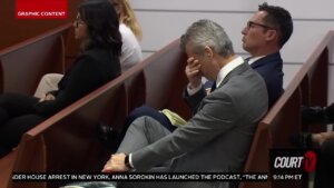 Man holds his head in his hands in court