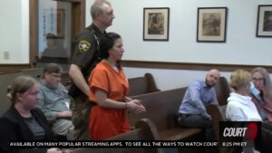 Taylor Schabusiness walks through court in shackles