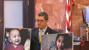 District Attorney Isidro Alaniz holds photos of Grizelda Hernandez and Dominic Alexander Hernandez.