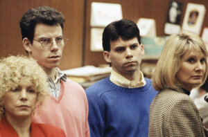 Lyle Menendez, right, and brother Erik listen to a charge of murder conspiracy against them